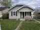 Modest single-Gathering home featuring a small front porch and dark green shutters at 335 S Dearborn St, Indianapolis, IN 46201
