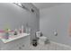 Bright bathroom with white vanity, toilet, and tiled floor at 3655 Yellow Poplar Ct, Indianapolis, IN 46222
