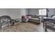 Comfortable living room showcasing laminate flooring, a sofa, and wicker furniture at 3655 Yellow Poplar Ct, Indianapolis, IN 46222