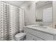 Clean bathroom with a modern vanity, stylish mirror, and shower featuring a decorative shower curtain at 3719 Lexham Ct, Danville, IN 46122