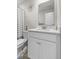 Bright bathroom features modern vanity with ample storage, stylish mirror, and clean, contemporary design at 3719 Lexham Ct, Danville, IN 46122