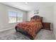 Well-lit bedroom with a red paisley comforter and bedside tables at 3719 Lexham Ct, Danville, IN 46122