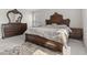 This bedroom features a decorative wood bedroom set, a neutral color palette, and lots of natural light at 3719 Lexham Ct, Danville, IN 46122