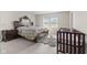 Spacious bedroom with a crib, bed and plenty of natural light at 3719 Lexham Ct, Danville, IN 46122