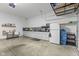 Garage features overhead rack for storage, and built in kitchenette with white painted cabinets at 3719 Lexham Ct, Danville, IN 46122