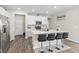 Bright kitchen features white cabinets, stainless steel appliances, and island with seating, perfect for entertaining at 3719 Lexham Ct, Danville, IN 46122