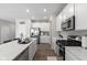 Spacious kitchen with stainless steel appliances, white cabinets, and a large island, offering ample counter space at 3719 Lexham Ct, Danville, IN 46122