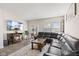 Comfortable living room featuring a fireplace, sliding door access to the backyard, and plush leather sofa at 3719 Lexham Ct, Danville, IN 46122