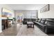 Comfortable living room with a fireplace, sliding door access to the backyard, and a plush leather sofa at 3719 Lexham Ct, Danville, IN 46122