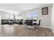 Open-concept living room and dining area with neutral tones, wood flooring, and ample natural light at 3719 Lexham Ct, Danville, IN 46122