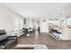 Spacious open-concept area connecting the living, dining, and kitchen, all with stylish wood flooring at 3719 Lexham Ct, Danville, IN 46122