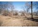 Large backyard with mature trees and room to roam; ready for your personal touch and design at 3813 N Hartman Dr, Indianapolis, IN 46226