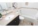 Cozy bathroom with a bathtub, stylish vanity, and well-coordinated design elements, blending comfort and aesthetics at 3813 N Hartman Dr, Indianapolis, IN 46226