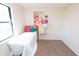 Neutral bedroom with white bedding, pink and blue pillows, and flamingo artwork at 3813 N Hartman Dr, Indianapolis, IN 46226