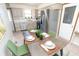 Bright, eat-in kitchen with a table set for dinner with modern appliances and white cabinets at 3813 N Hartman Dr, Indianapolis, IN 46226