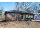 Cozy one-story brick house with tidy landscaping and a welcoming front door at 3813 N Hartman Dr, Indianapolis, IN 46226