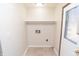 Compact laundry area with essential hookups, offering functionality in a clean and organized space at 3813 N Hartman Dr, Indianapolis, IN 46226