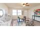 Bright living room with a large window, comfortable seating, and a stylish ceiling fan at 3813 N Hartman Dr, Indianapolis, IN 46226