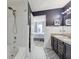 Bathroom with double sinks, black cabinets, and a shower at 3832 Kilburn Ct, Indianapolis, IN 46228