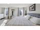 Bedroom with a patterned bed, light gray walls, wood-look floors, and a mirror at 3832 Kilburn Ct, Indianapolis, IN 46228