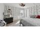 Cozy bedroom with unique wallpaper, a neutral rug, and decorative lamps at 3832 Kilburn Ct, Indianapolis, IN 46228