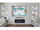 Close-up of a modern fireplace with a large flatscreen TV and built-in shelves at 3832 Kilburn Ct, Indianapolis, IN 46228
