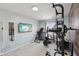 Bright home gym with modern equipment, a large flat-screen TV, and a window for natural light at 3832 Kilburn Ct, Indianapolis, IN 46228