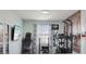 Spacious home gym with exercise equipment, a wall-mounted TV, and a decorative wood accent wall at 3832 Kilburn Ct, Indianapolis, IN 46228