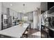 Spacious kitchen with stainless steel appliances, hardwood floors, island, gray cabinets and modern lighting at 3832 Kilburn Ct, Indianapolis, IN 46228