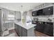 Updated kitchen featuring an island with a white countertop, and gray cabinets at 3832 Kilburn Ct, Indianapolis, IN 46228