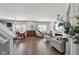 Open-concept living room with hardwood floors, a stone fireplace, and a modern design at 3832 Kilburn Ct, Indianapolis, IN 46228