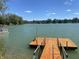 Private wooden dock leading to the lake provides stunning views and recreational opportunities at 5515 Shorewood Dr, Indianapolis, IN 46220