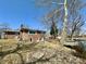 Backyard of the brick home featuring a pond, wooden dock, and small shed at 5850 Paradise Ln, Martinsville, IN 46151