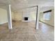 Spacious basement featuring tiled floor, window with blinds, a decorative fireplace, and support columns at 5850 Paradise Ln, Martinsville, IN 46151