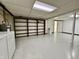 Unfinished basement area with laundry machines, open shelving and white painted walls at 5850 Paradise Ln, Martinsville, IN 46151