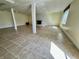 Spacious basement featuring tiled floor, decorative fireplace, support columns, and natural light at 5850 Paradise Ln, Martinsville, IN 46151