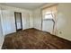 Bedroom features neutral walls, carpet, closet, and a window with lace curtains at 5850 Paradise Ln, Martinsville, IN 46151