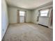 A bright, empty bedroom with wall-to-wall carpet offers two windows with curtains for natural light at 5850 Paradise Ln, Martinsville, IN 46151