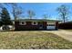 Charming single-story brick home with an attached garage and well-kept lawn on a sunny day at 5850 Paradise Ln, Martinsville, IN 46151