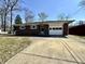 Charming one-story brick home with an attached garage, a concrete driveway, and mature trees at 5850 Paradise Ln, Martinsville, IN 46151