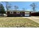 Charming one-story brick home with an attached garage, a well-maintained lawn, and mature trees at 5850 Paradise Ln, Martinsville, IN 46151