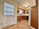 Cozy kitchen featuring wood cabinets, tile countertops, and a window letting in natural light at 5850 Paradise Ln, Martinsville, IN 46151
