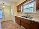 Bright kitchen featuring wood cabinets, tile countertops, and a view to the outside from the window at 5850 Paradise Ln, Martinsville, IN 46151