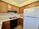 Kitchen with classic wood cabinets, electric range, tile backsplash, and a refrigerator at 5850 Paradise Ln, Martinsville, IN 46151