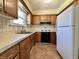 Functional kitchen with wood cabinets, tile backsplash, modern appliances, and ample countertop space at 5850 Paradise Ln, Martinsville, IN 46151