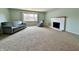 Inviting living room featuring a white fireplace, plush carpet, and ample space for relaxation at 5850 Paradise Ln, Martinsville, IN 46151