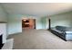 The carpeted living room offers a brick fireplace and is painted a cool green color at 5850 Paradise Ln, Martinsville, IN 46151