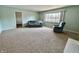 Inviting living room with a sofa, chair, carpet, and a large window with a view of the yard at 5850 Paradise Ln, Martinsville, IN 46151