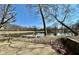 Scenic view of the pond featuring a wooden dock, clear water, and a backdrop of trees at 5850 Paradise Ln, Martinsville, IN 46151