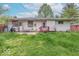 Backyard view featuring a patio, open lawn and the home's exterior at 613 Barrett St, Danville, IN 46122